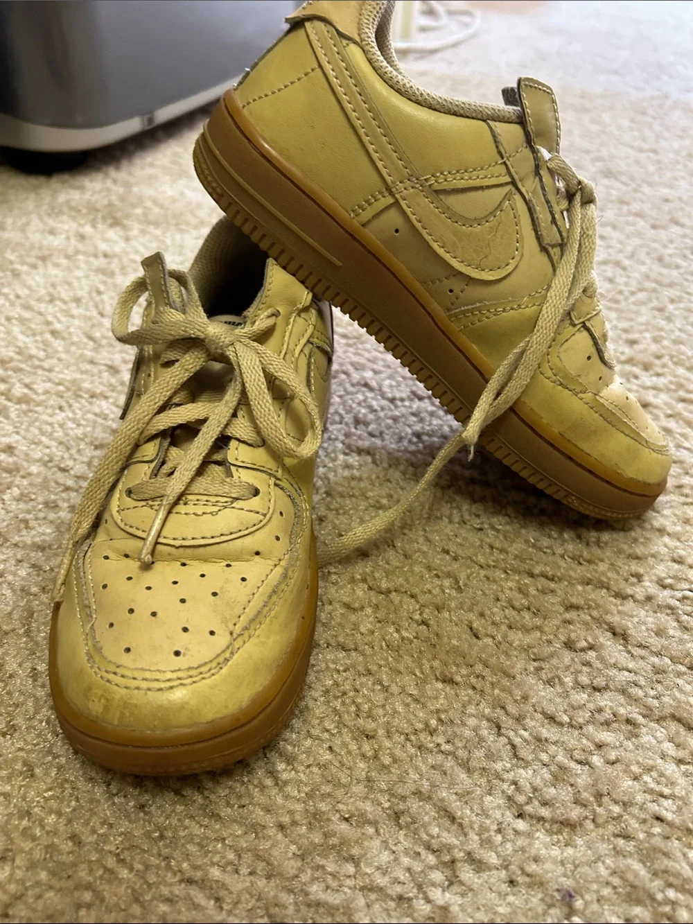 Nike Kids beige/tan sneakers.